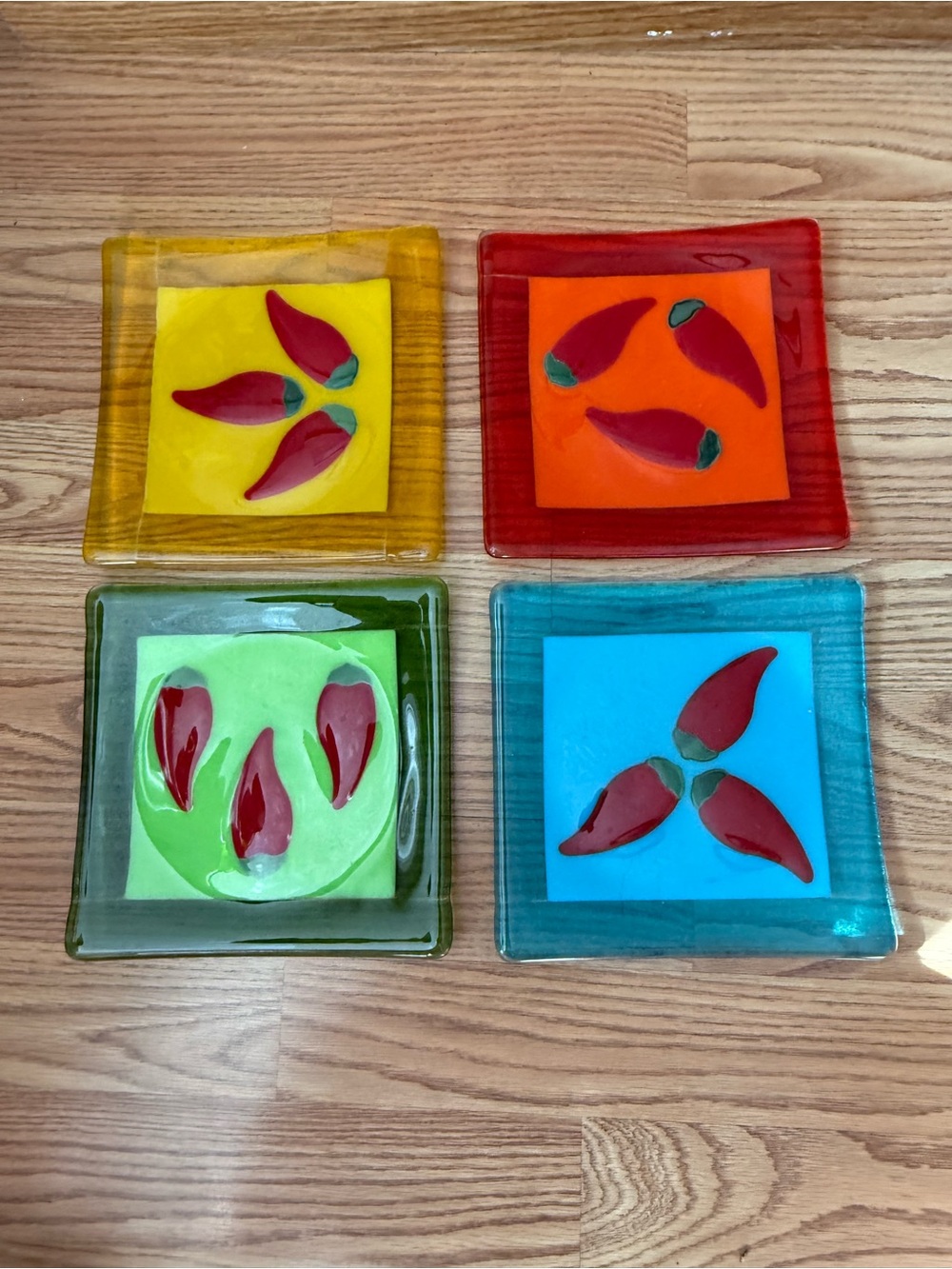 4  fused glass square plates featuring chili peppers design